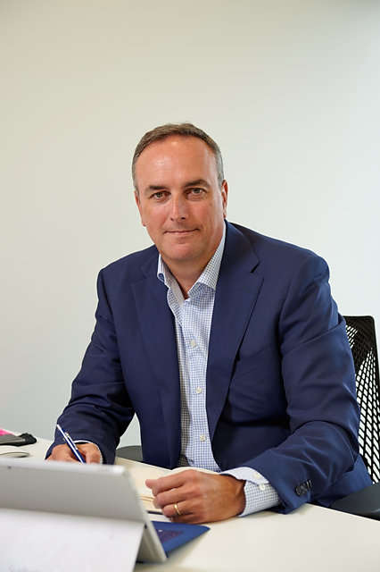 Editorial portrait photograph of Scott Dodds working at his desk, VMware VP Channel & Alliances EMEA